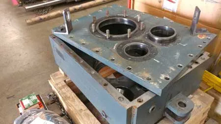 A large heavy metal gearcase is prepared for service.
